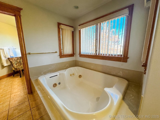 bathroom with tiled tub and tile patterned floors