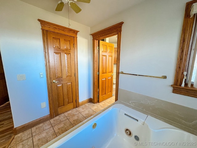 bathroom with tile patterned flooring, a bath, and ceiling fan