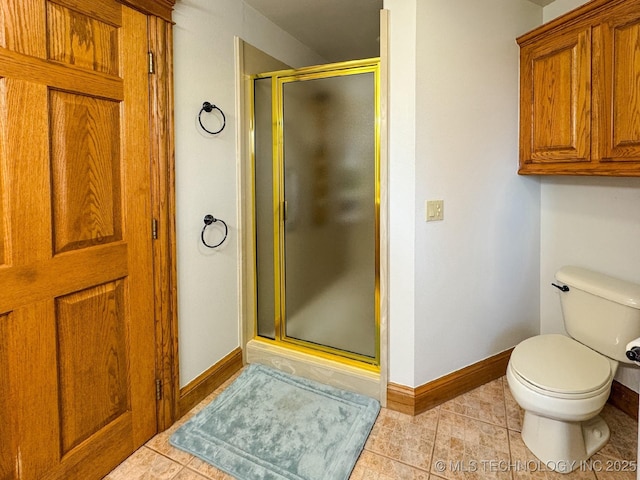 bathroom featuring a shower with shower door, tile patterned floors, and toilet