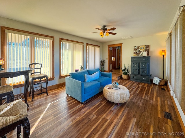 living room with ceiling fan and dark hardwood / wood-style floors