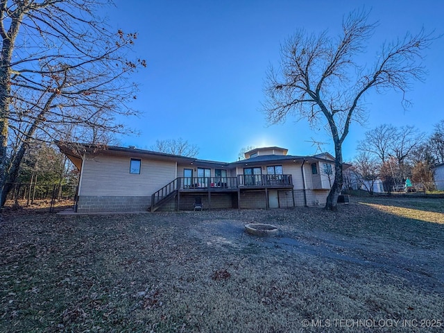 back of property featuring a wooden deck