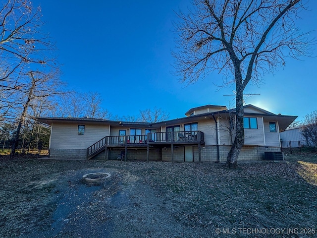 back of property with a wooden deck and cooling unit