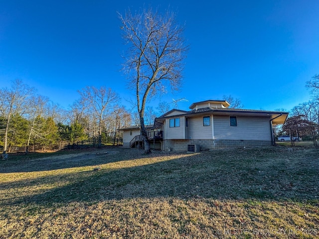 back of house with a wooden deck, a yard, and central air condition unit