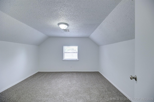 bonus room with a textured ceiling, carpet, and lofted ceiling