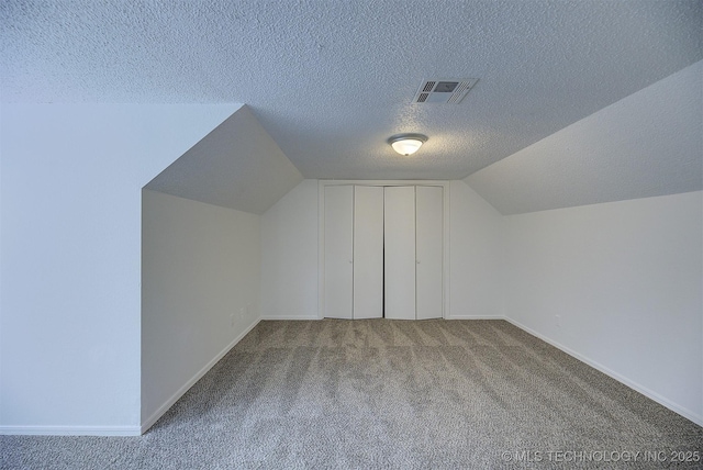 bonus room with carpet, a textured ceiling, and vaulted ceiling