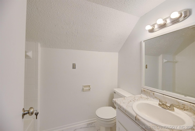 bathroom with vanity, vaulted ceiling, toilet, a textured ceiling, and walk in shower