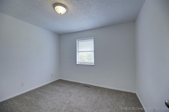 carpeted spare room featuring a textured ceiling