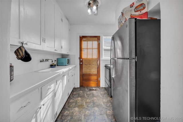 kitchen featuring white cabinetry, sink, and stainless steel appliances