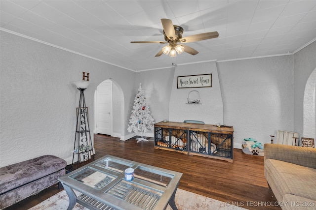 living room featuring hardwood / wood-style flooring, ceiling fan, and ornamental molding