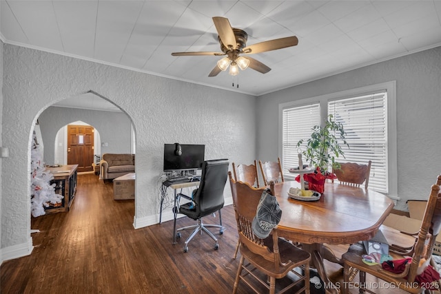 dining space featuring dark hardwood / wood-style flooring, ceiling fan, and ornamental molding