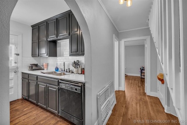 kitchen featuring dishwasher, sink, hardwood / wood-style flooring, ornamental molding, and heating unit