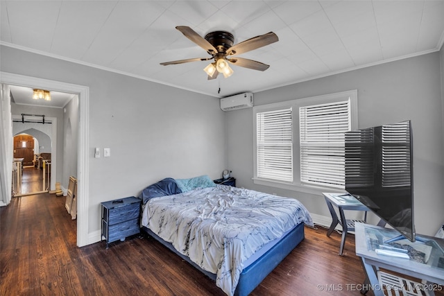 bedroom featuring dark hardwood / wood-style floors, a wall unit AC, ceiling fan, and ornamental molding