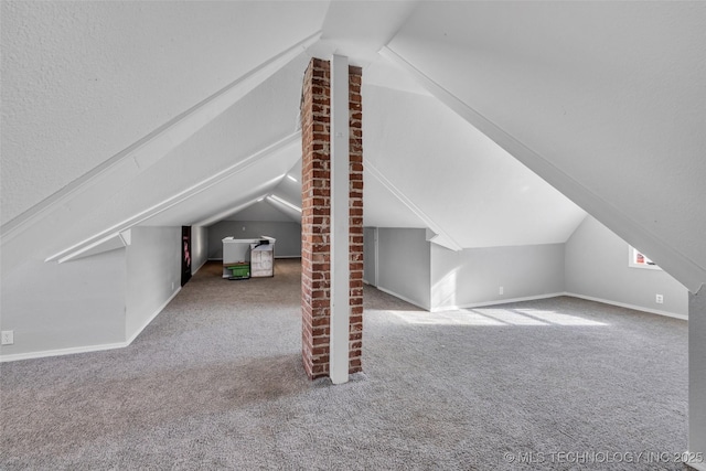 bonus room with carpet flooring and lofted ceiling