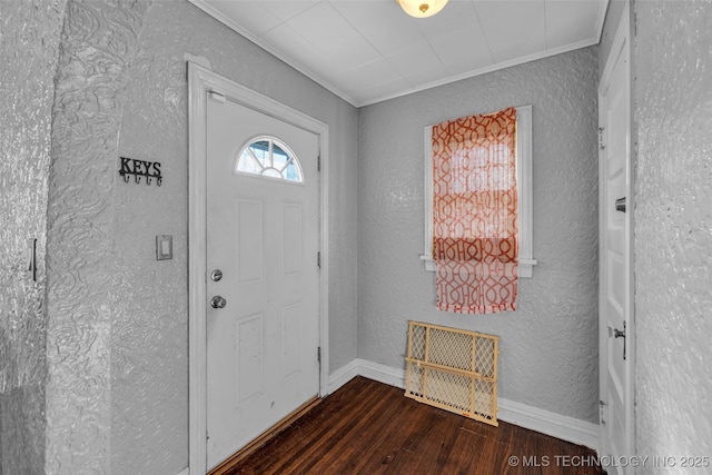 foyer entrance with dark hardwood / wood-style floors and ornamental molding