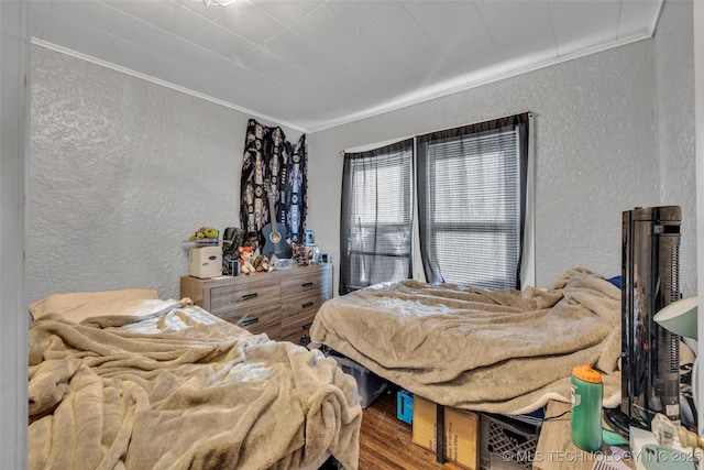 bedroom with hardwood / wood-style flooring and ornamental molding