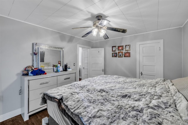 bedroom with ceiling fan and dark wood-type flooring