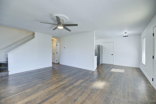 unfurnished living room featuring a textured ceiling, dark hardwood / wood-style flooring, and ceiling fan