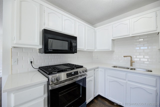 kitchen with white cabinetry, decorative backsplash, stainless steel range with gas cooktop, and sink