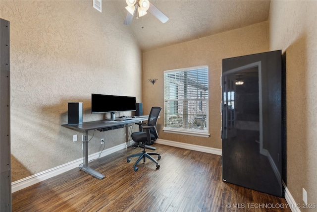 office space featuring ceiling fan, dark hardwood / wood-style floors, and vaulted ceiling