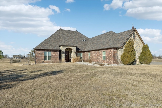 french country home featuring a front lawn