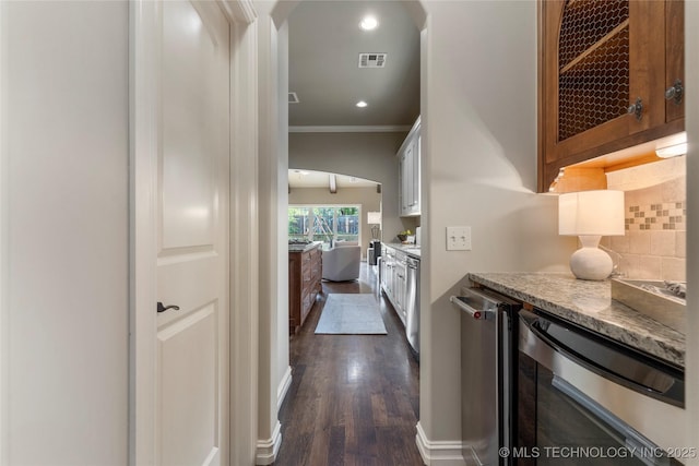 hall with crown molding, beverage cooler, and dark wood-type flooring