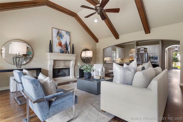 living room with ceiling fan, light hardwood / wood-style flooring, and lofted ceiling with beams