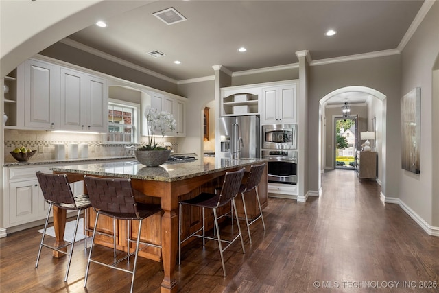 kitchen with a center island, white cabinets, and appliances with stainless steel finishes