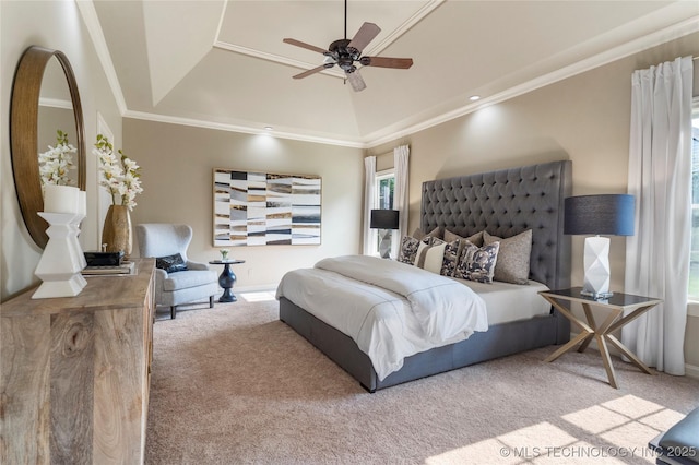 bedroom featuring carpet, ceiling fan, ornamental molding, and a tray ceiling