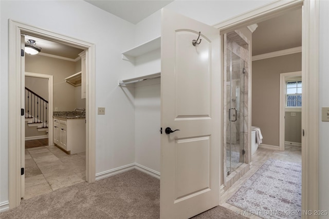 bathroom with vanity, ornamental molding, and walk in shower