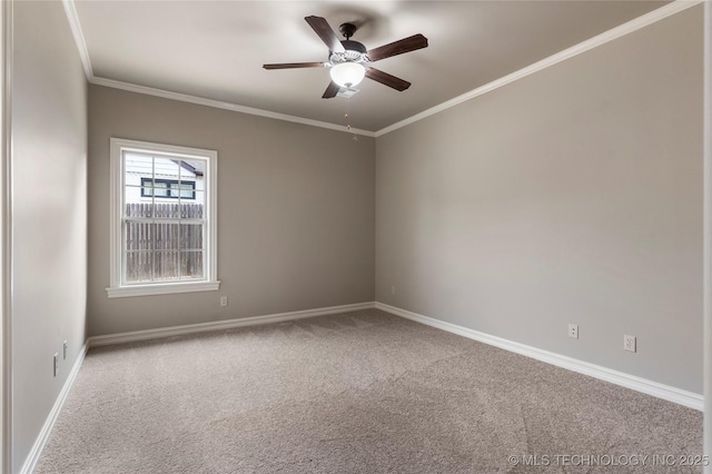 carpeted spare room featuring ceiling fan and crown molding