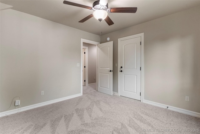 unfurnished bedroom with light colored carpet and ceiling fan