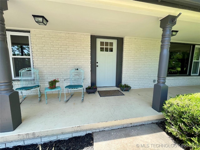 view of exterior entry with a porch