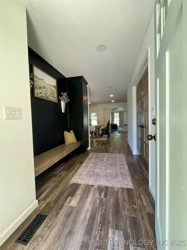 hallway with french doors and dark wood-type flooring