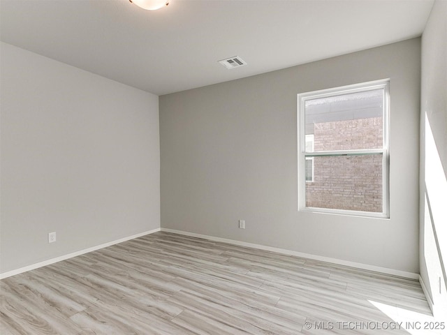 unfurnished room with light hardwood / wood-style flooring