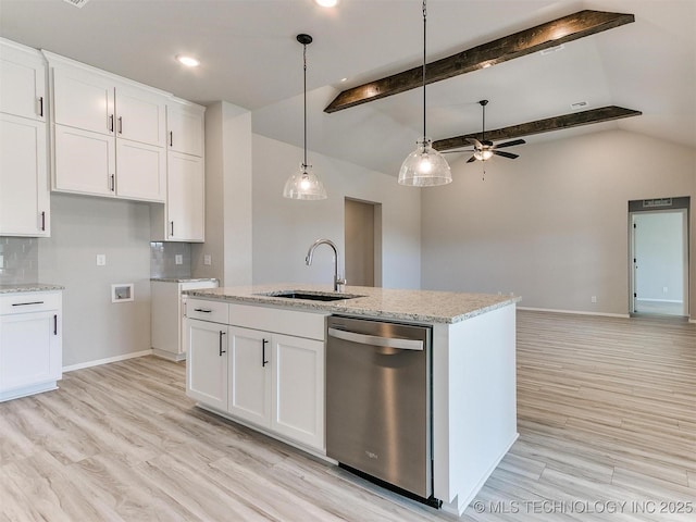 kitchen featuring decorative backsplash, dishwasher, white cabinets, and sink