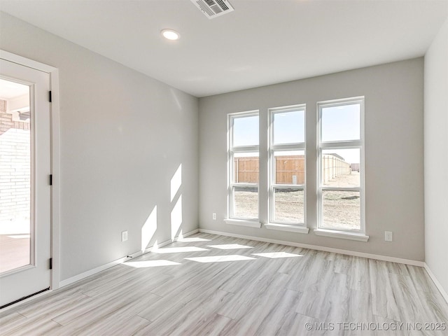 spare room featuring light hardwood / wood-style flooring