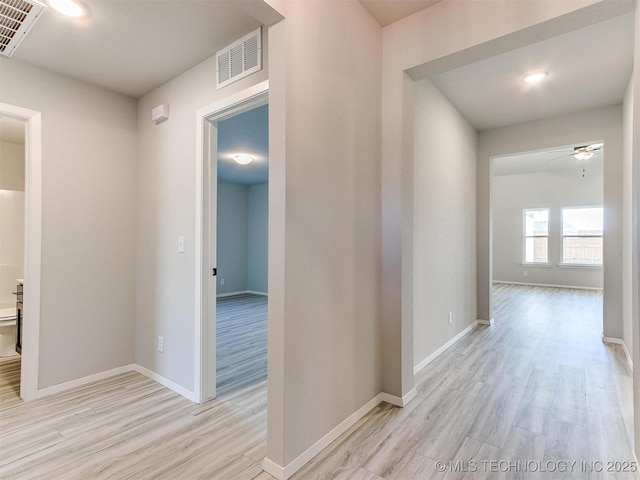 corridor with light hardwood / wood-style flooring