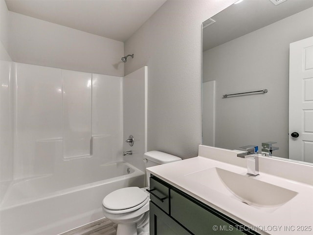 full bathroom with vanity, toilet, wood-type flooring, and shower / washtub combination