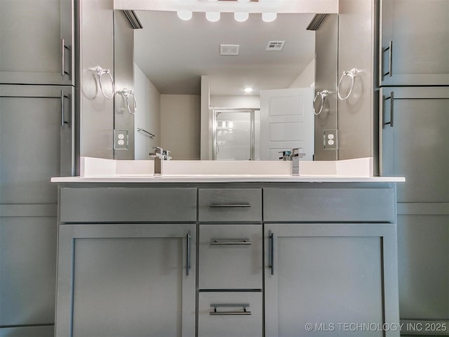 bathroom with vanity and a shower with shower door