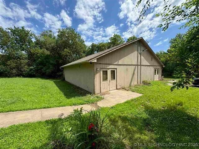 view of side of property with a yard