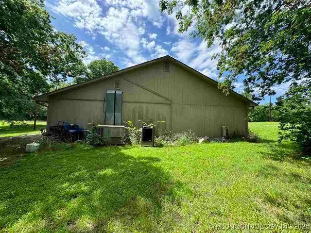 back of property featuring a lawn