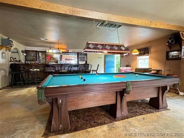 game room with bar and pool table