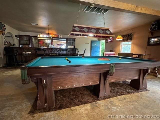 rec room featuring indoor bar, pool table, and concrete floors