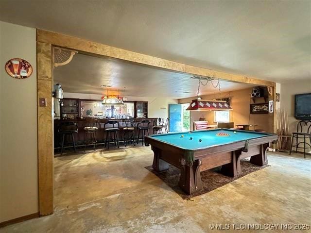 playroom featuring concrete flooring, bar area, and billiards