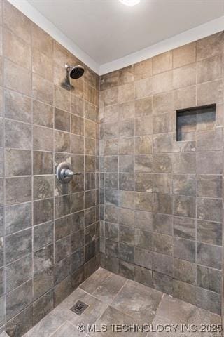 bathroom with tiled shower