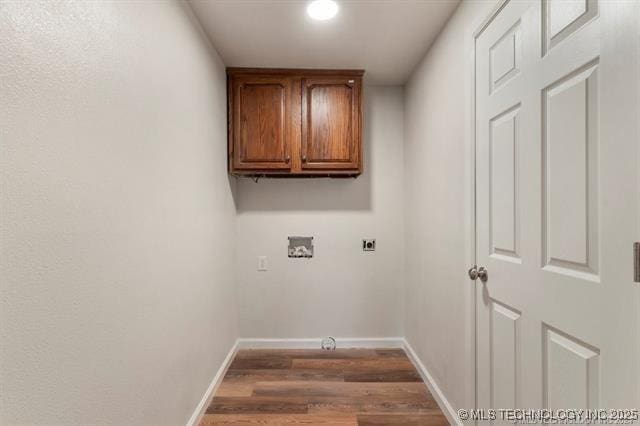 clothes washing area featuring electric dryer hookup, cabinets, hookup for a washing machine, and dark wood-type flooring