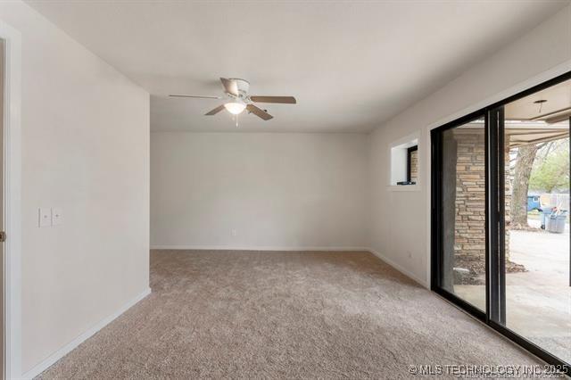 empty room with carpet and ceiling fan