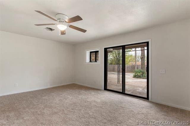 empty room featuring light colored carpet and ceiling fan