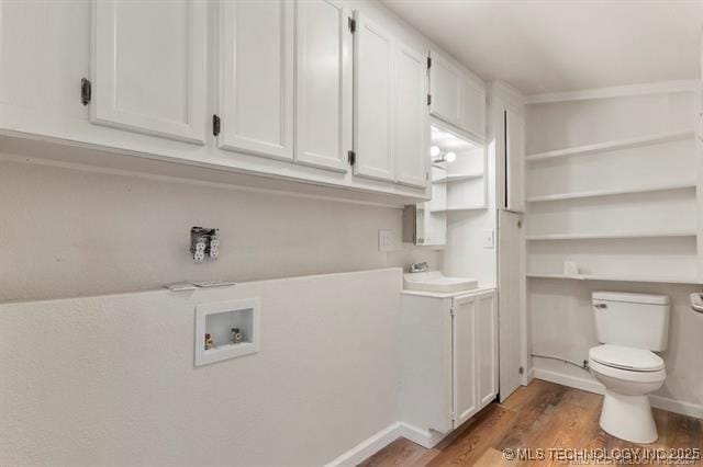 laundry room with hookup for a washing machine, dark hardwood / wood-style flooring, and sink