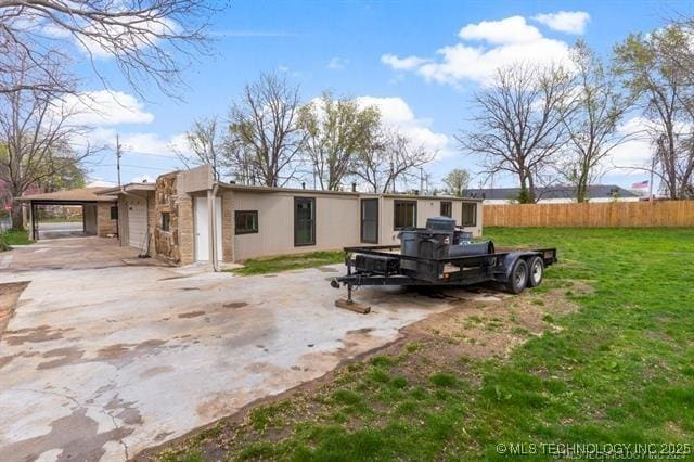 ranch-style home featuring a carport and a front yard